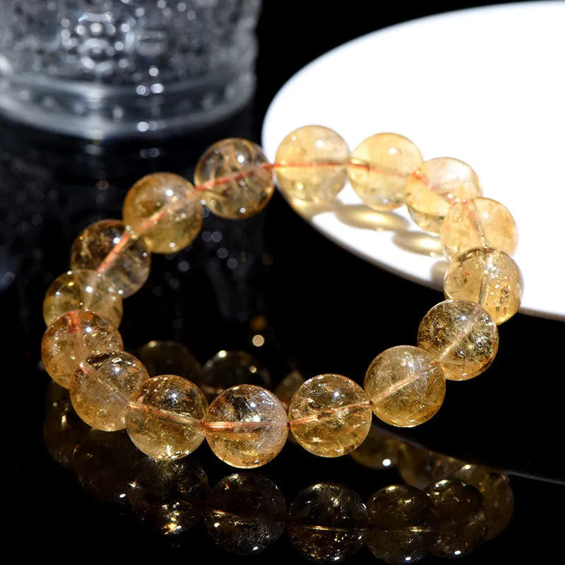 Natural yellow citrine bracelet with geometric beads in various sizes from 4mm to 20.8mm diameter on wrist