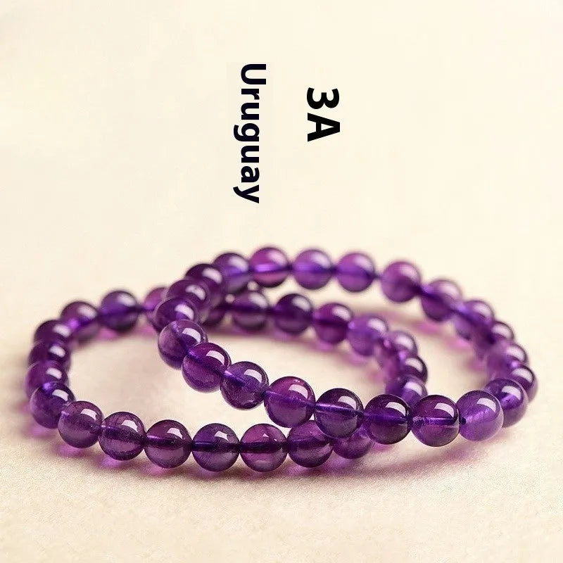 Natural amethyst scattered beads bracelet from Uruguay showing purple crystal beads in various sizes from 4mm to 16mm diameter