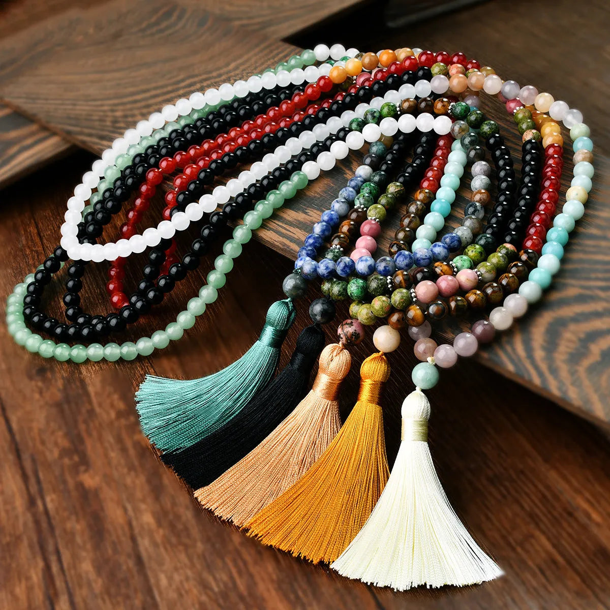 Long beaded necklace with geometric pendant and natural stone tassels in green aventurine.