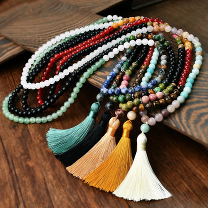 Long beaded necklace with geometric pendant and natural stone tassels in green aventurine.