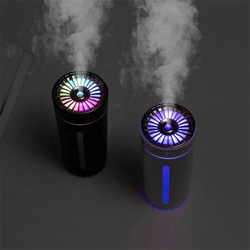 Black wireless car humidifier with colourful LED lights shown in vehicle cup holder
