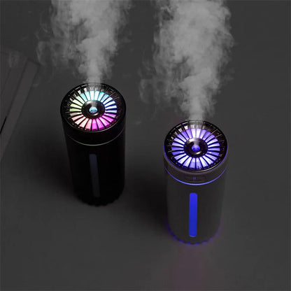 Black wireless car humidifier with colourful LED lights shown in vehicle cup holder
