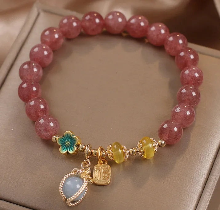 Red women's bracelet with strawberry quartz beads and rhinestones on an alloy chain.