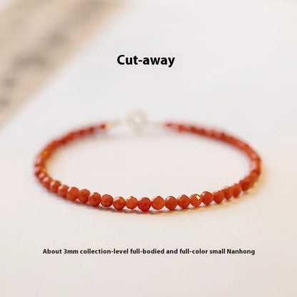 Close-up of a women's retro bracelet with a Southern Red Agate stone in cherry red on a wrist.