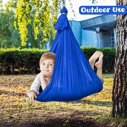 Child in black therapy swing cocoon with multi-loop daisy chain height adjustment system