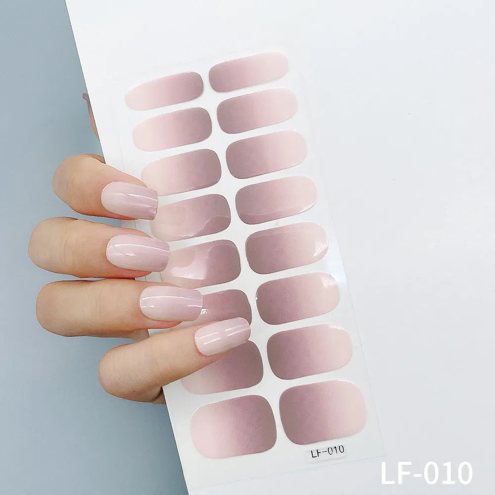 Sheet of 16 small design nail art stickers including cross, rose, tulip and marble patterns.