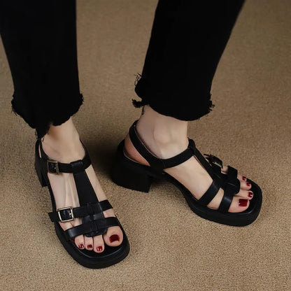 Black women's retro sandals with T-buckle, chunky heel, and open square toe.