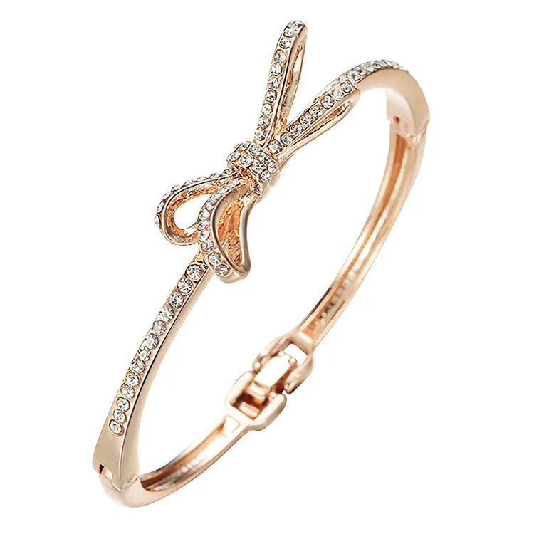 Women's rose gold alloy bracelet with bow design, diamond accent, and electroplated copper finish