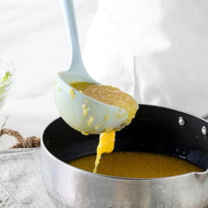 Blue silicone non-stick cookware set with frying spatula, colander, egg beater, and white iron storage bucket for kitchen organisation