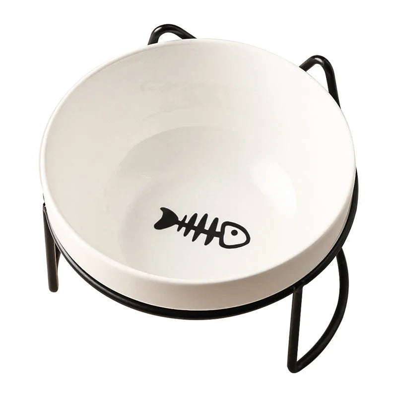 White ceramic pet bowl with cat paw design on a black iron frame raised feeder.