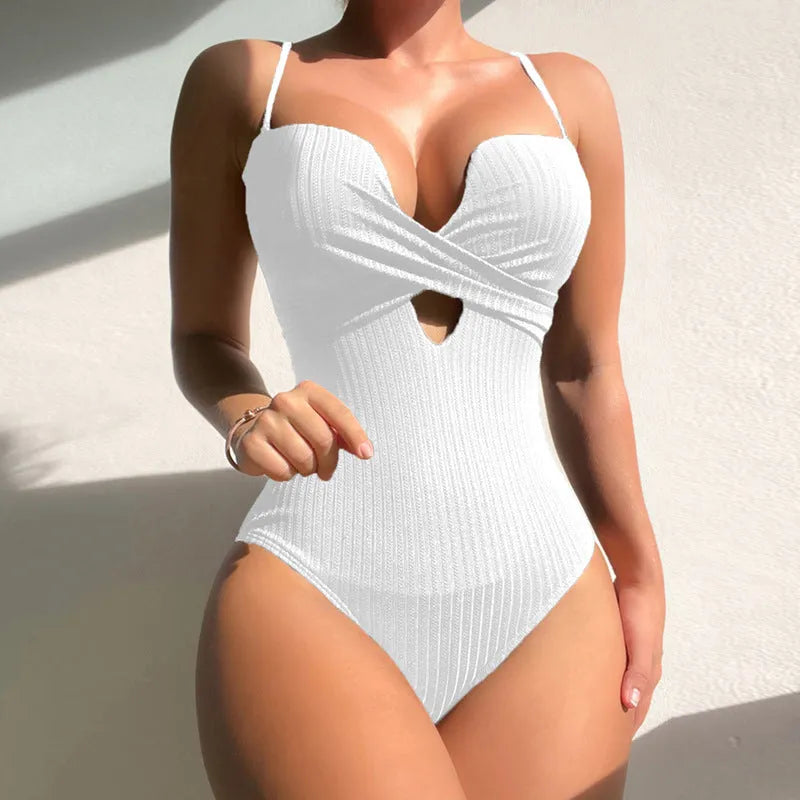 Women's solid colour one-piece swimsuit in polyester fabric showing slim fit design