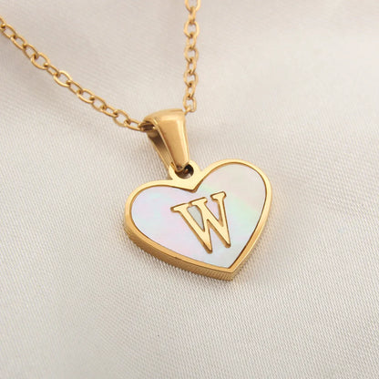 Gold-plated clavicle necklace with a white shell heart pendant, personalised with a letter from A to Z.