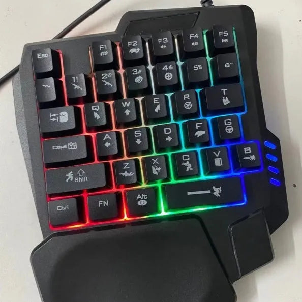 Black one-handed mechanical keyboard and mouse set with a 1.5 metre USB cable on a desktop.