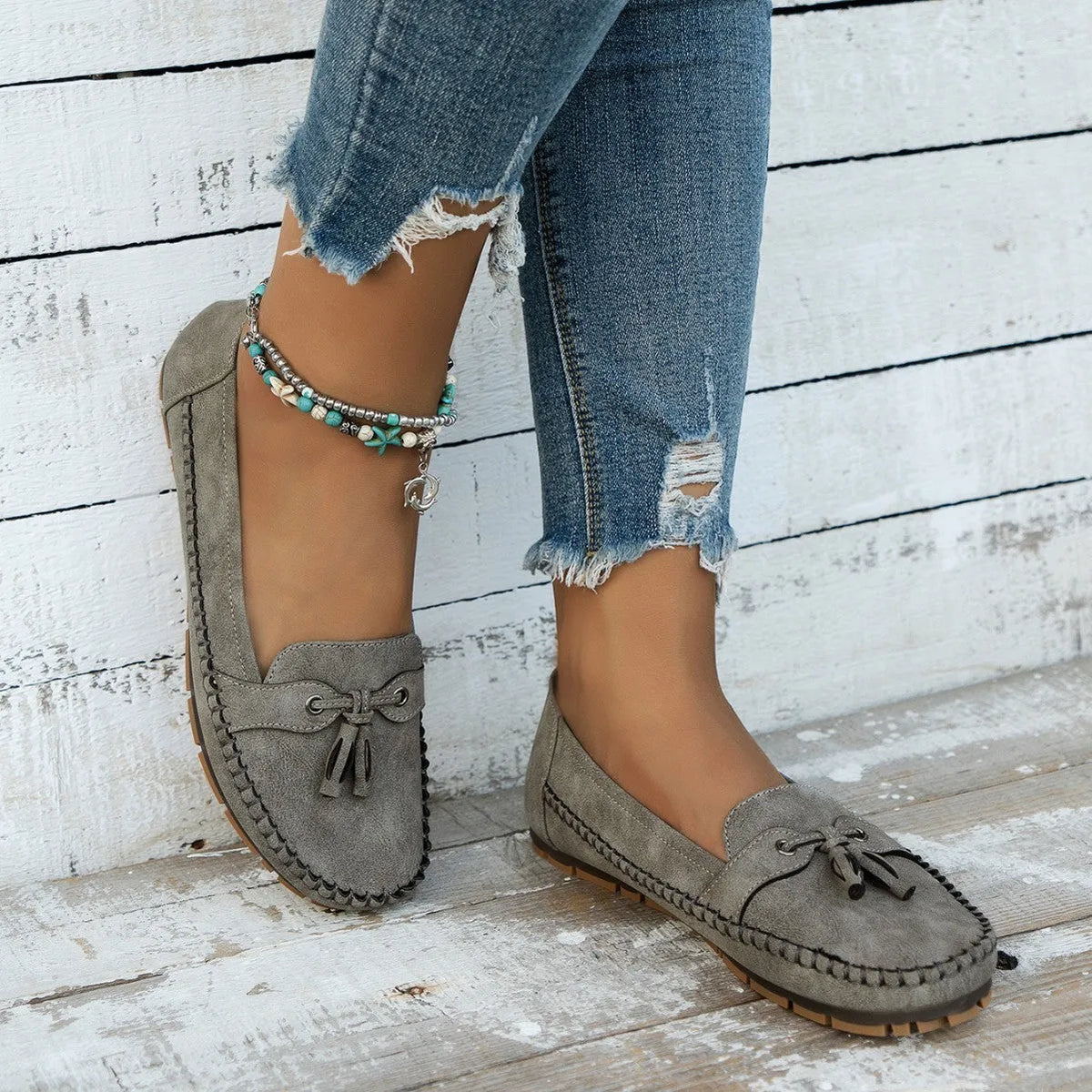 Women's casual suede flat shoes with decorative bow and round toe in apricot colour