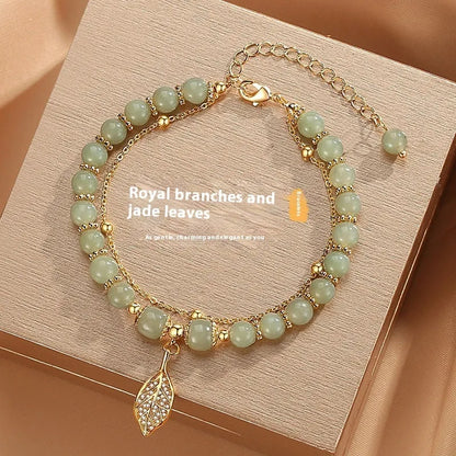 Chinese style glass bead bracelet with bamboo joint design on wrist.