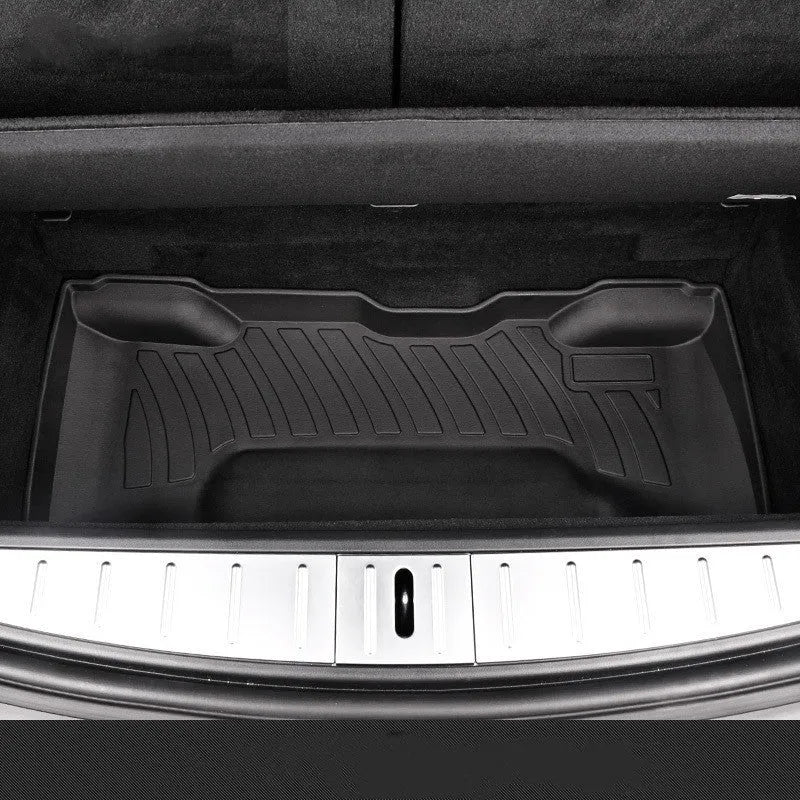 Black TPE rubber floor mats for Tesla Model 3, showing deep grooves and raised edges on driver's side.
