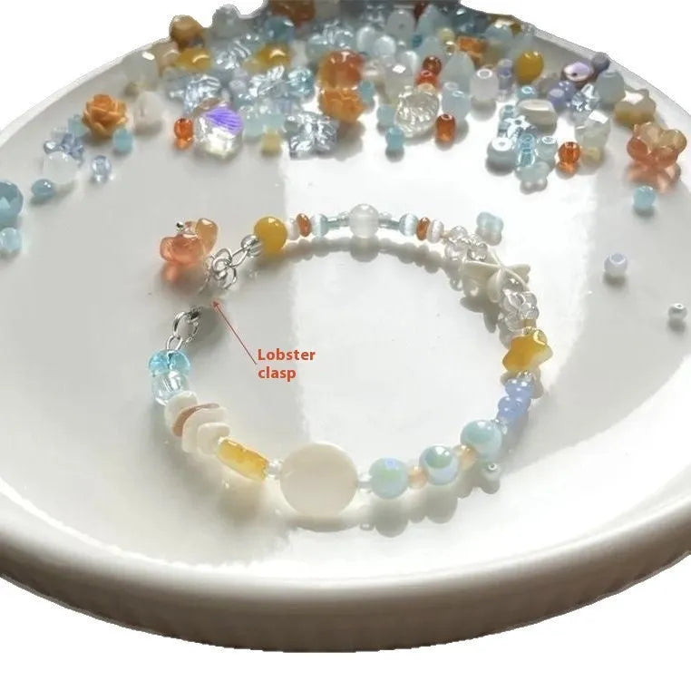 Women's orange mixed material bracelet with a diamond shape and round decorative elements.