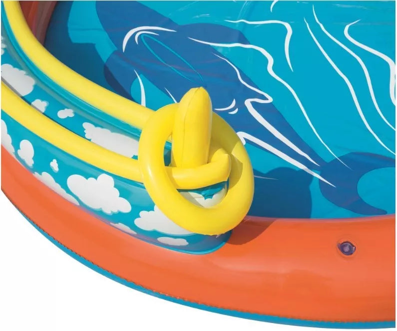 Children playing in an inflatable volcano-shaped pool with sprinkler and toys