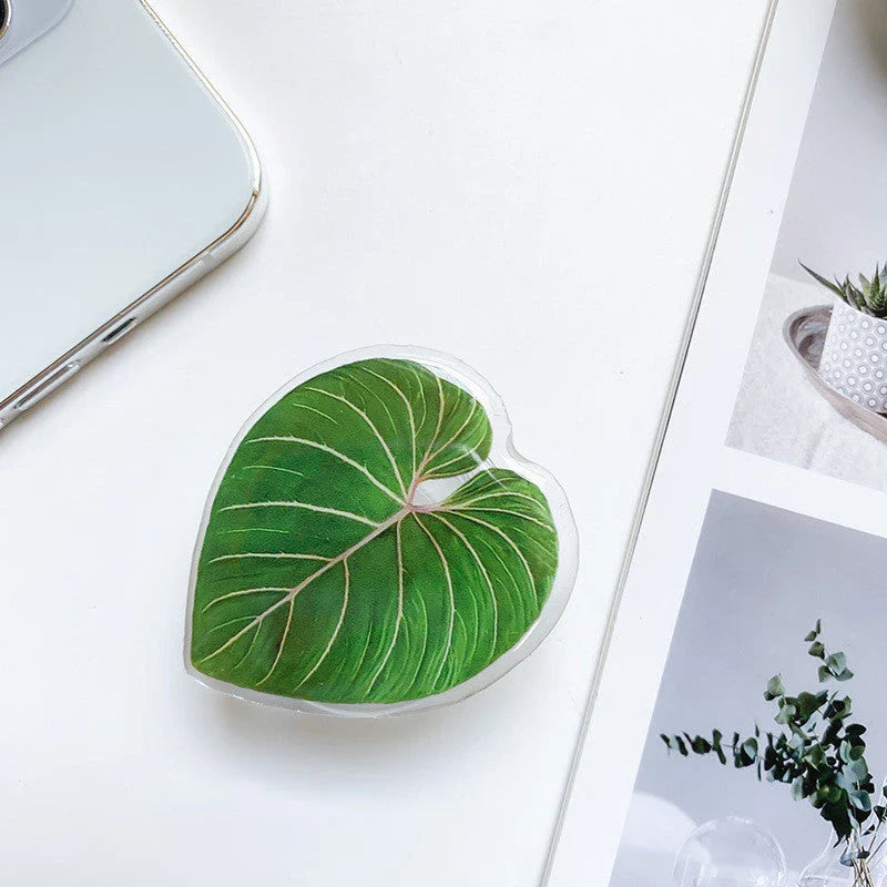 Stylish leaf-inspired smartphone stand with secure grip and adjustable viewing angle for hands-free use