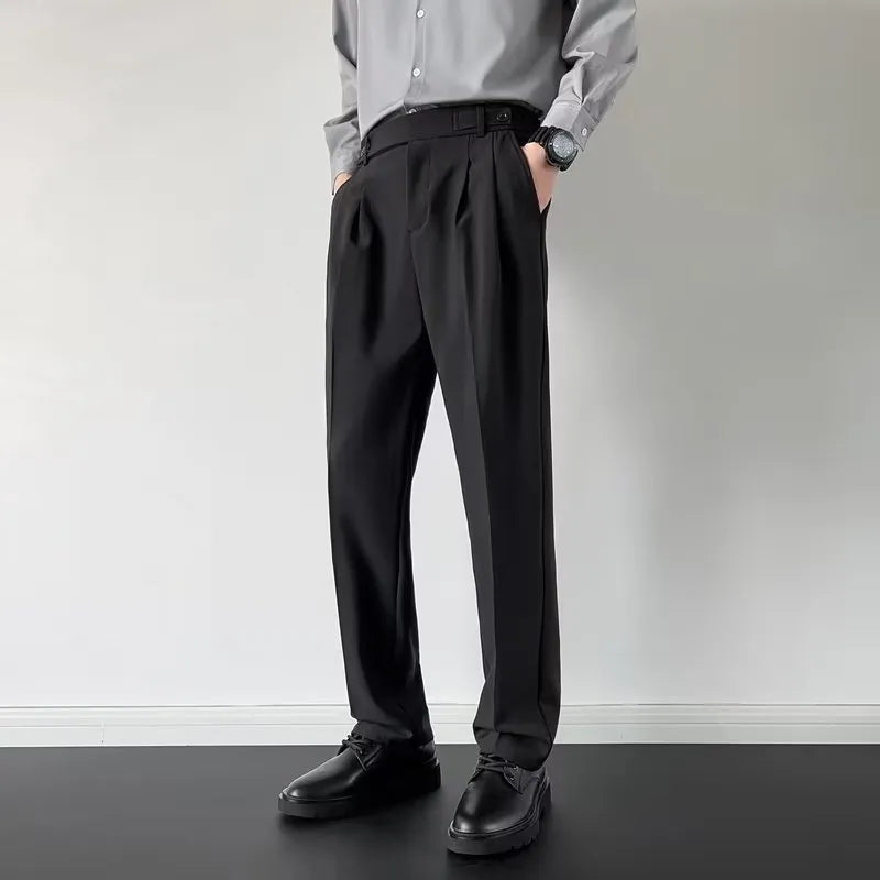 Men's apricot and black straight-leg loose fit suit trousers on a hanger.