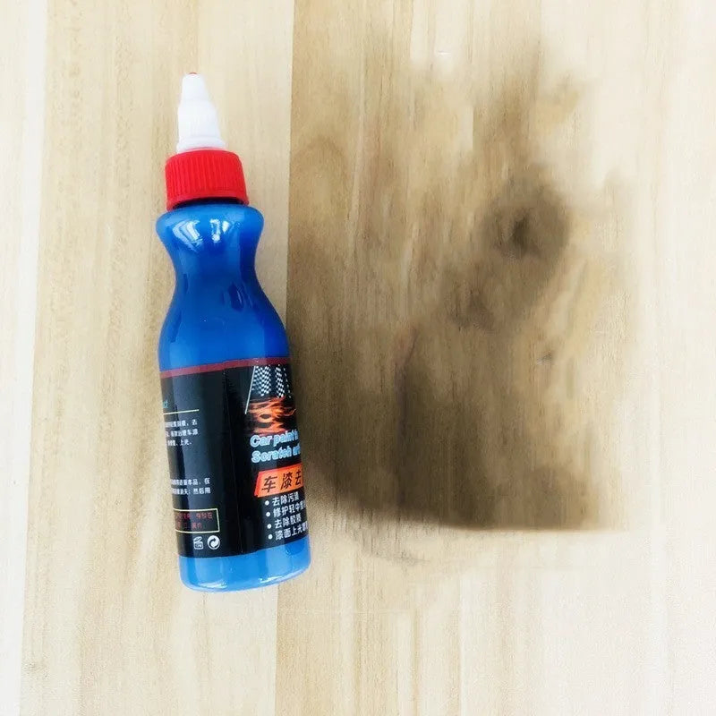 Blue car scratch repair agent container with microfiber cloth for minor automotive surface imperfections