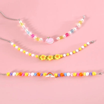 Colourful plastic bead cat necklace with adjustable clasp showing peach, rainbow, and small flower pattern options