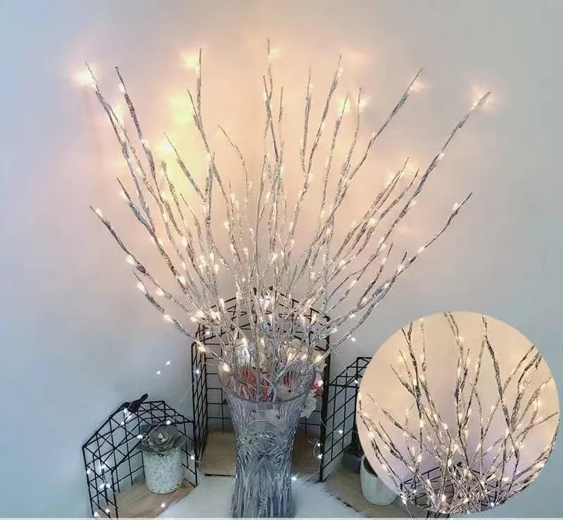 Silver branch LED tree light in a vase with multiple colour change modes including blue, pink, and warm white.