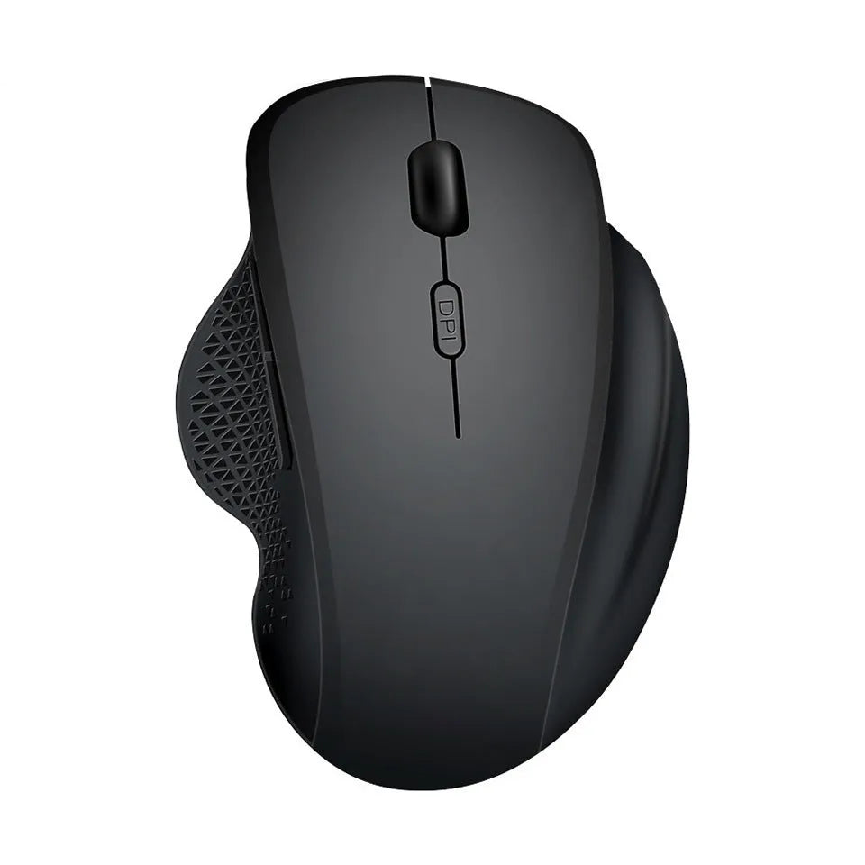 Compact grey wireless mouse with USB charging cable on a wooden desk next to a laptop.