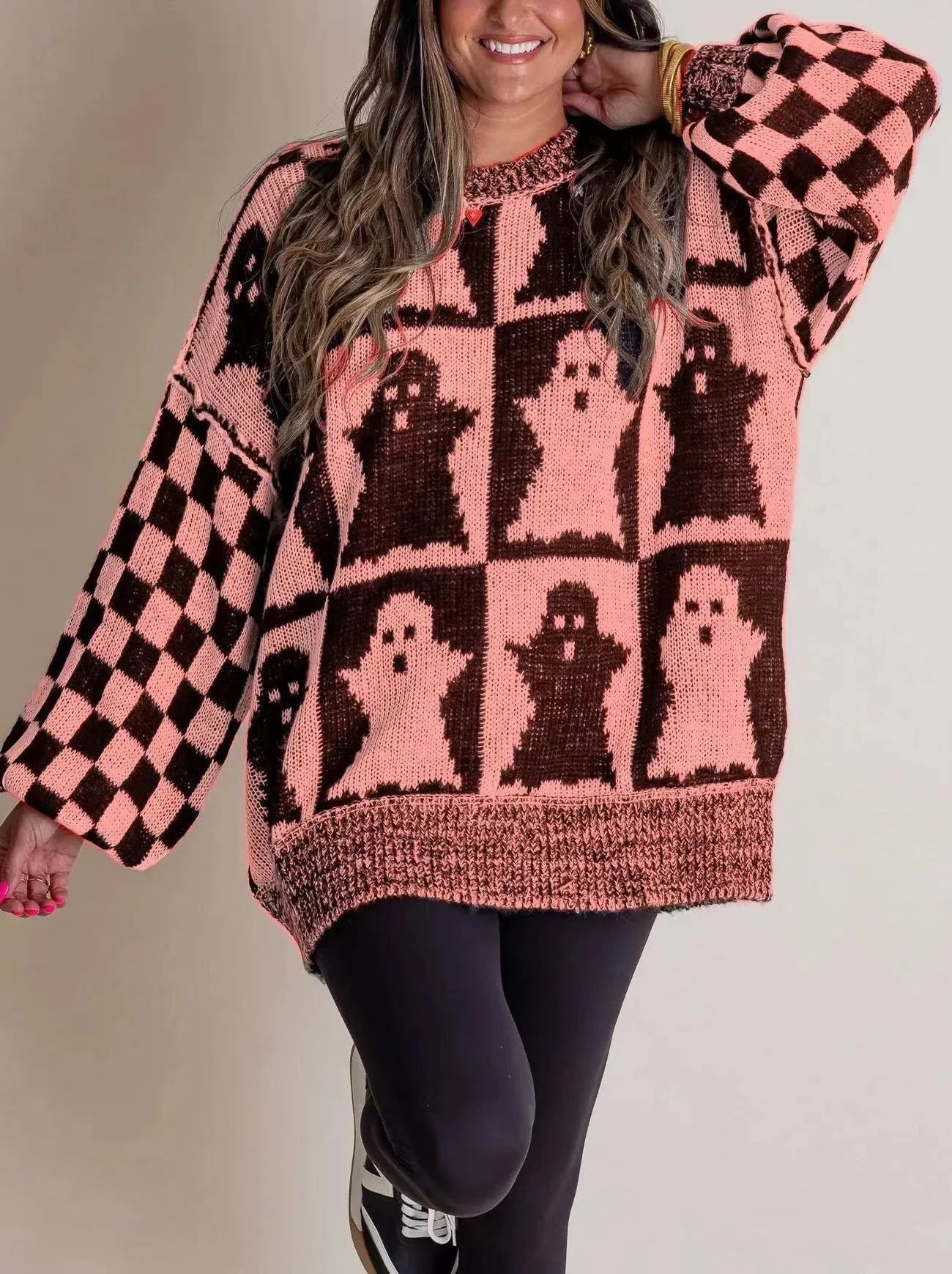 A stylish Halloween sweater featuring a unique pumpkin and ghost graphic design, available in a variety of fashion-forward colors.