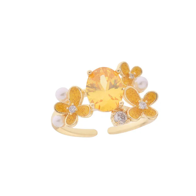 Adjustable open ring with flower design featuring pearl and zircon elements in yellow or light purple finish