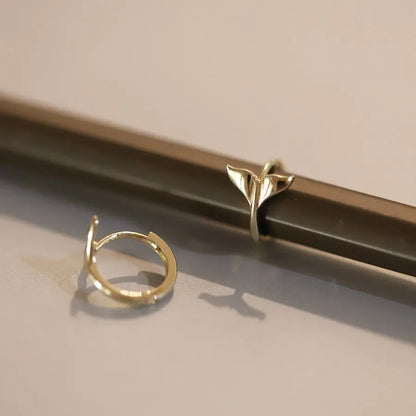 Pair of S925 sterling silver fishtail earrings with 14k gold plating in gold colour.