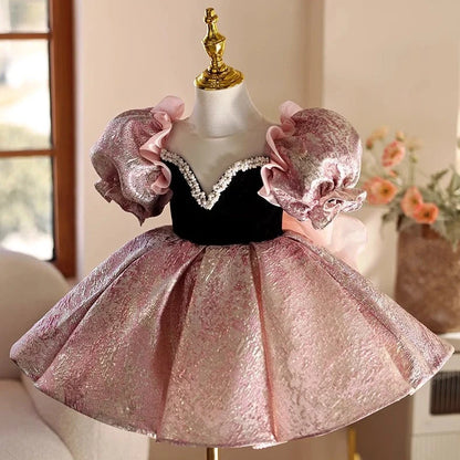 Pink children's princess dress with cute design elements, shown on hanger