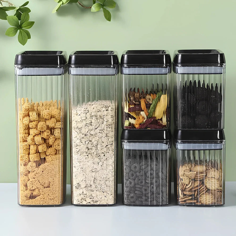 Six black food storage containers with lids in two sizes: two large 3.3-litre and four smaller 1.5-litre jars