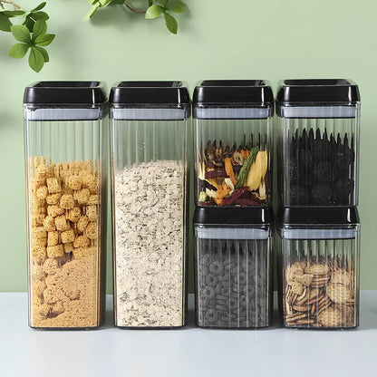 Six black food storage containers with lids in two sizes: two large 3.3-litre and four smaller 1.5-litre jars