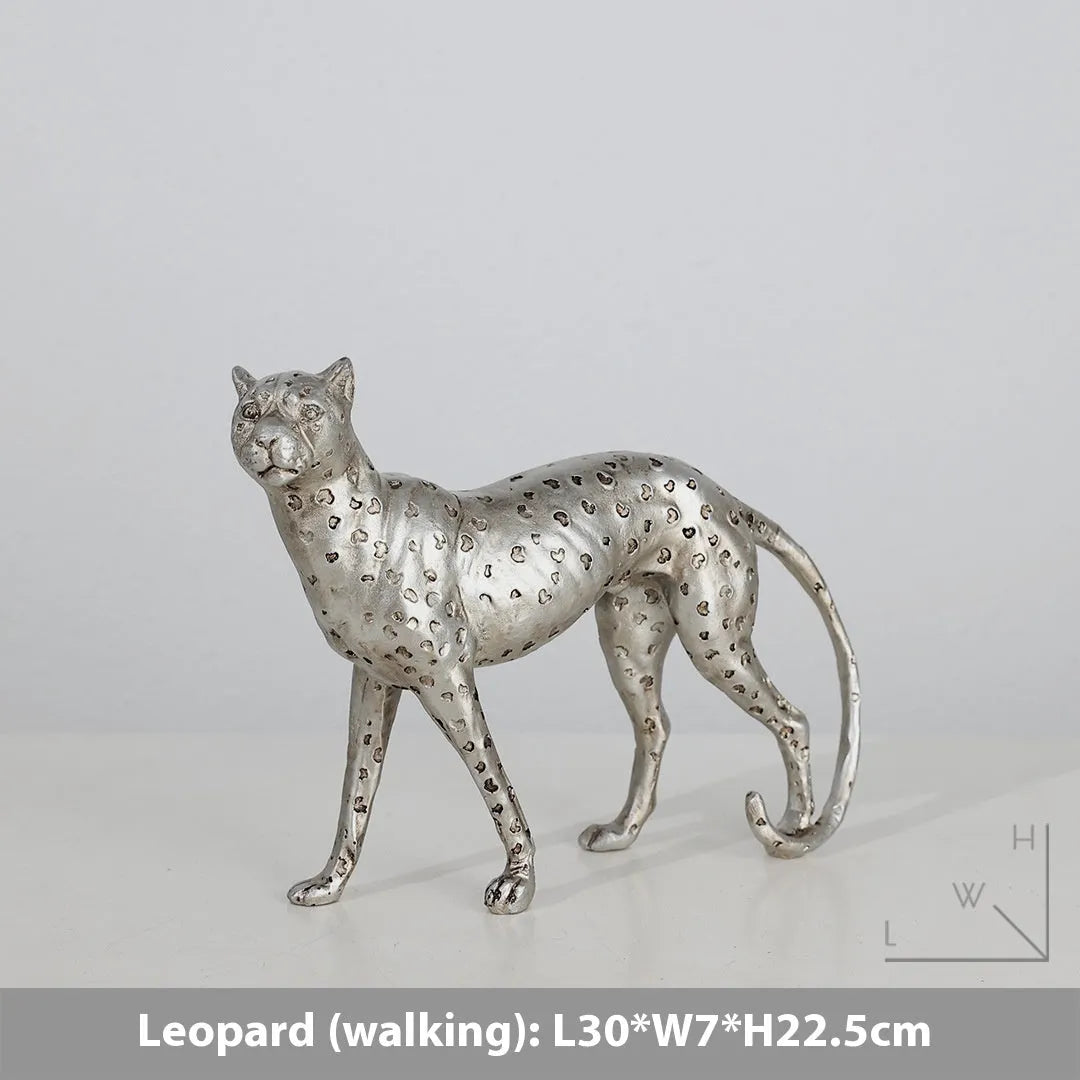 Leopard resin home ornament in American Leopard colour showing three pose variations on wooden surface