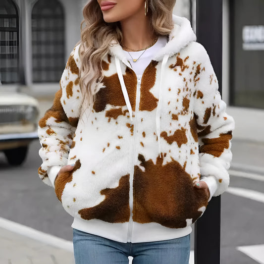 Yellow and brown cow print hooded cardigan jacket with a front zipper, shown on a model.