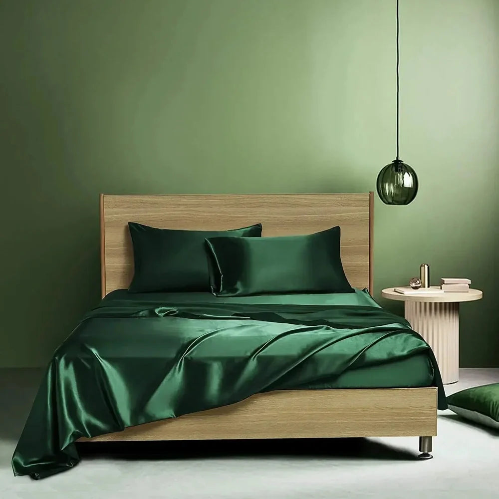 Navy blue floral pattern silk bedding set with quilt cover, fitted sheet, and two pillowcases on bed