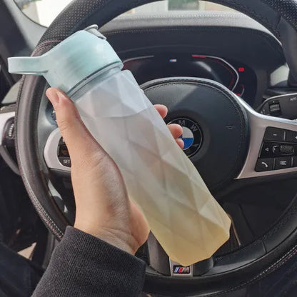 Large plastic spray water bottle with handle strap and leakproof lid in green colour.