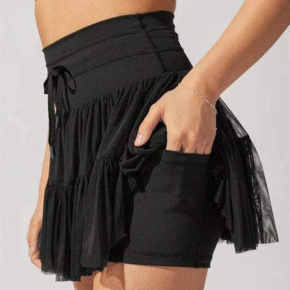 Stylish high-waist pleated mini skirt with lace-up design and built-in anti-exposure safety shorts, available in a variety of vibrant colors.