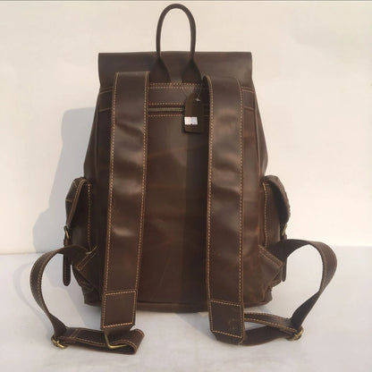 Men's brown leather backpack showing cowhide texture and air pillow belt system