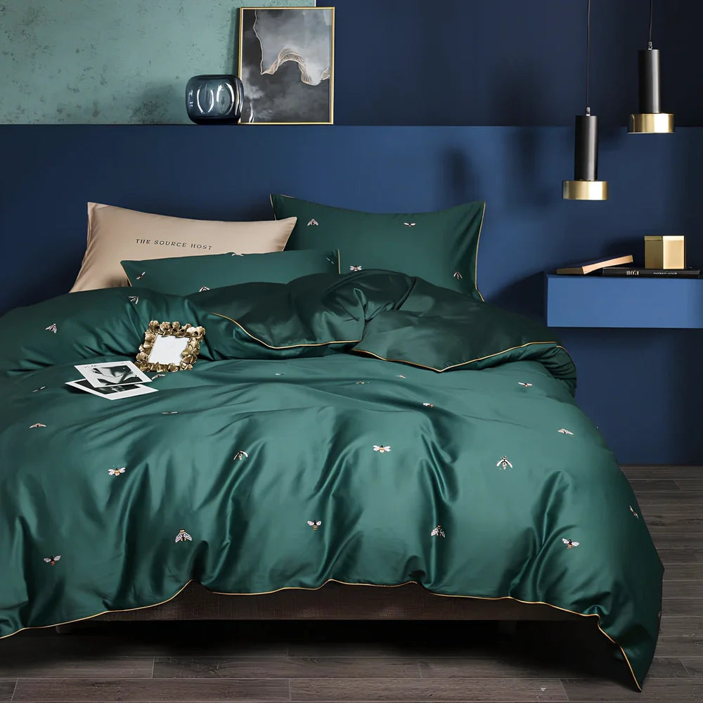 Four-piece cotton bedding set with floral pattern showing fitted sheet, duvet cover, and two pillowcases