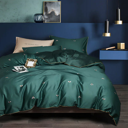 Four-piece cotton bedding set with floral pattern showing fitted sheet, duvet cover, and two pillowcases