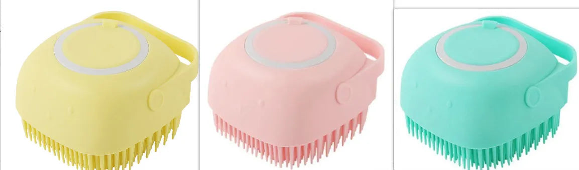 Blue silicone dog bath and massage brush held in a hand.