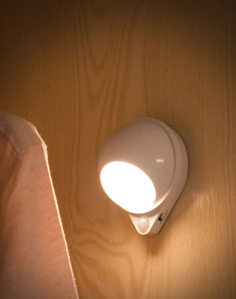 Wireless motion sensor light with USB charging port and adhesive mounting for wall installation