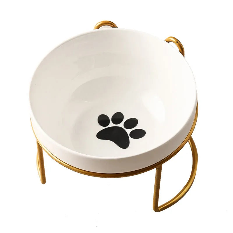 White ceramic pet bowl with cat paw design on a black iron frame raised feeder.