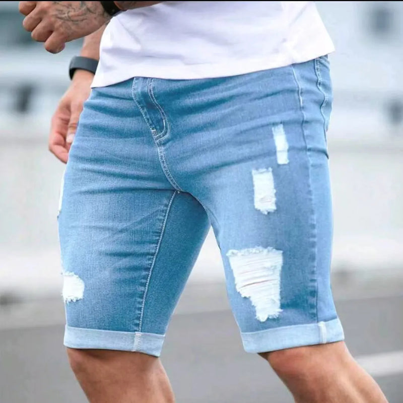 Denim shorts for men with multi-hole distressed design in summer sky blue colour featuring a low waist, straight cut leg, and zipper fly closure available in S, M, L, XL, and 2XL sizes.