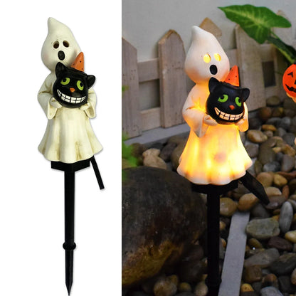Solar-powered Halloween pumpkin lanterns lighting up a garden at night