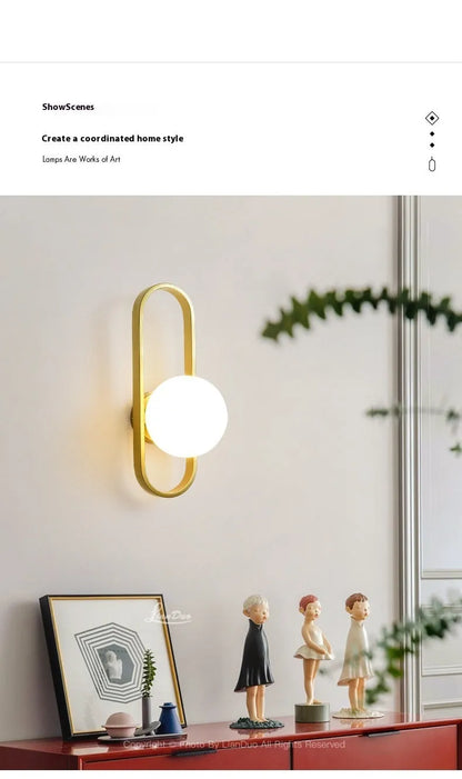 Minimalist wall lamp in black or gold finish with glass shade and 12W tri-colour LED lighting