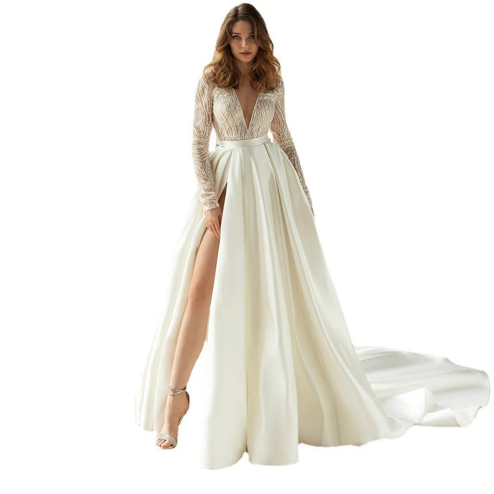 White long-sleeved mid-waist dress with gilded hollow-out detailing, shown in full length.