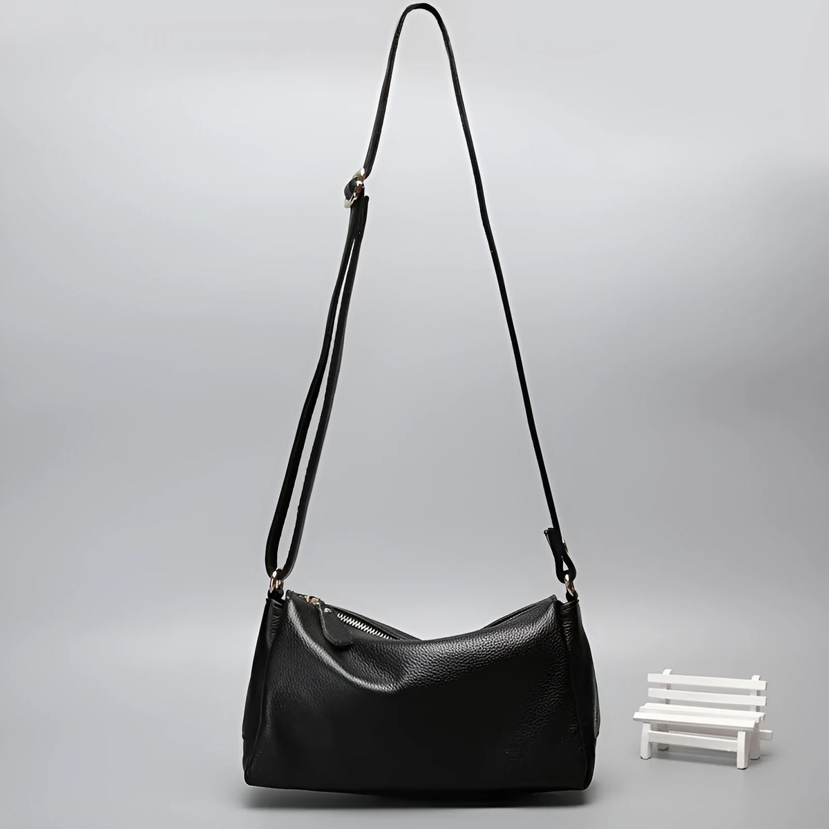 Soft genuine leather women's crossbody bag in horizontal square shape with single shoulder strap.